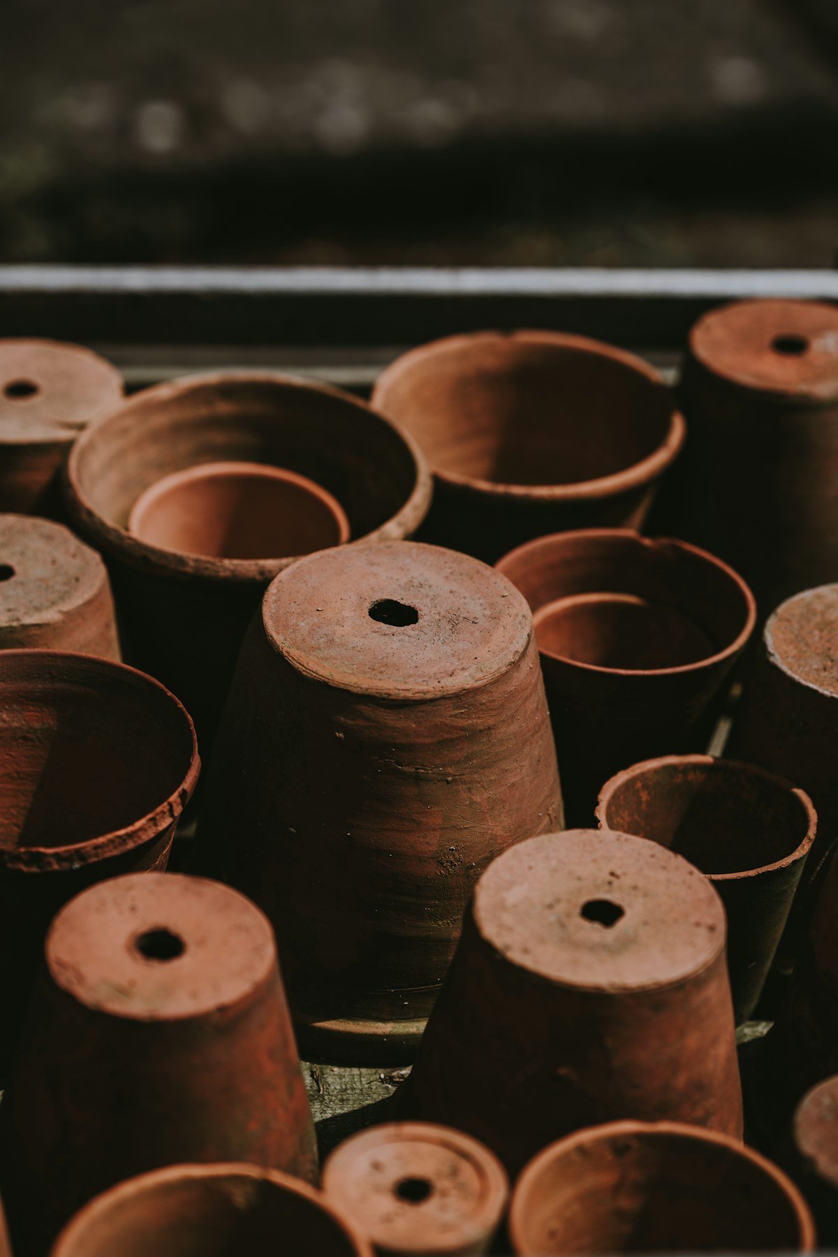 Stacked terracotta pots with drainage holes for a low-maintenance indoor plant setup